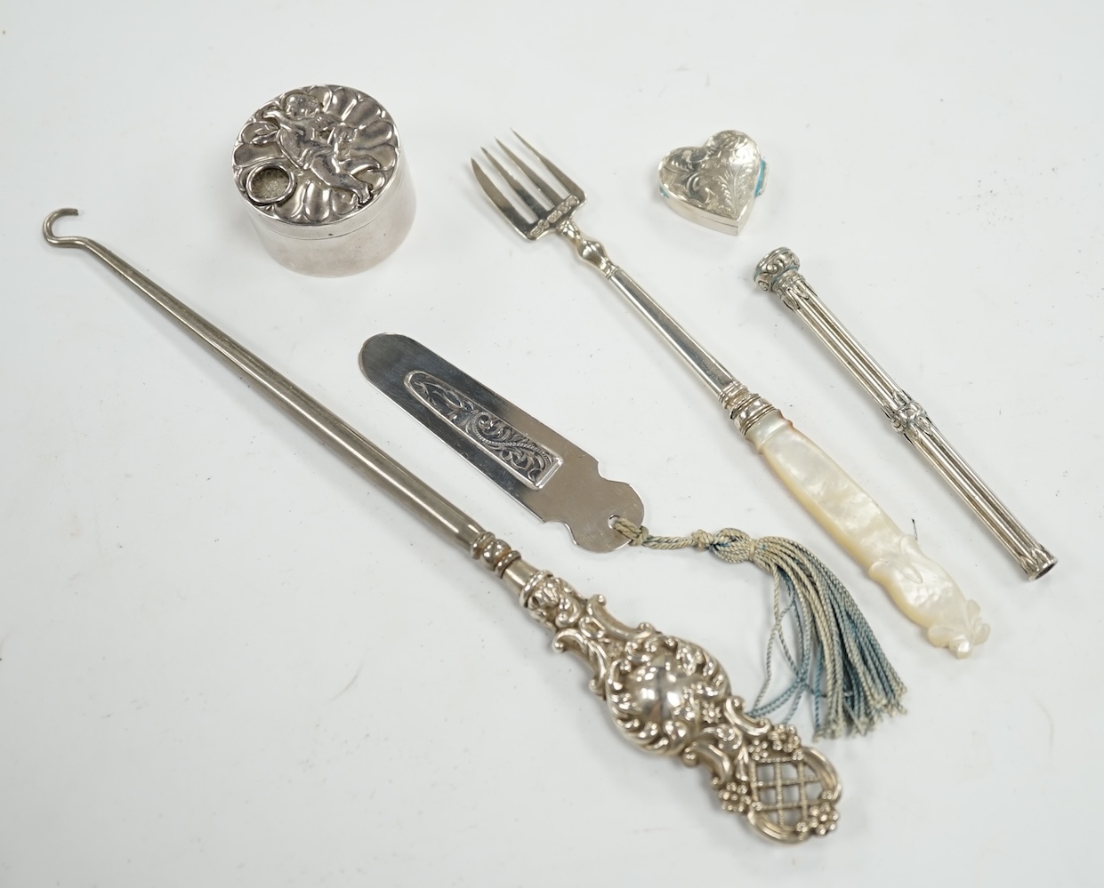 Small silver including a late Victorian slide action pill box, Birmingham, 1890, a heart shaped pill box, a book mark, pencil, pickle fork and a button hook